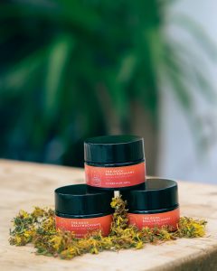 three containers of hypericum heal stacked in a pyramid