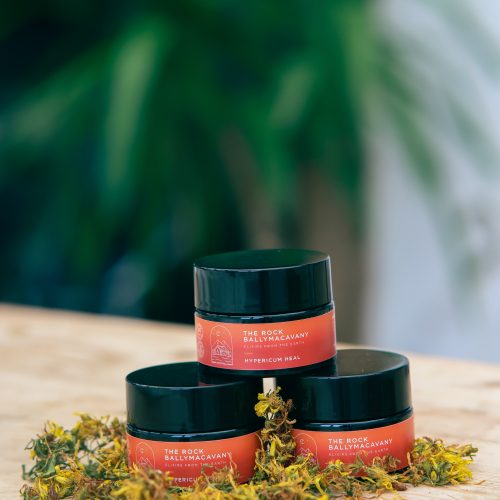 three containers of hypericum heal stacked in a pyramid