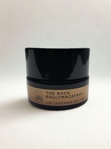 Black container of lip butter
